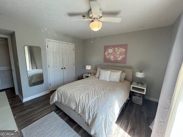 bedroom with a textured ceiling, wood finished floors, a closet, baseboards, and ceiling fan