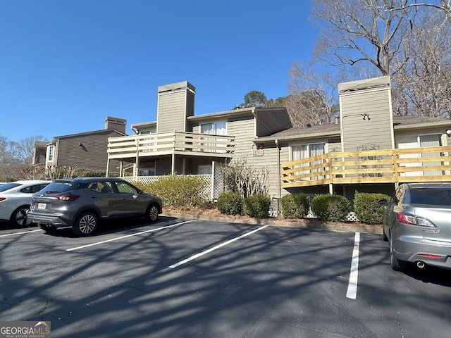 view of building exterior featuring uncovered parking