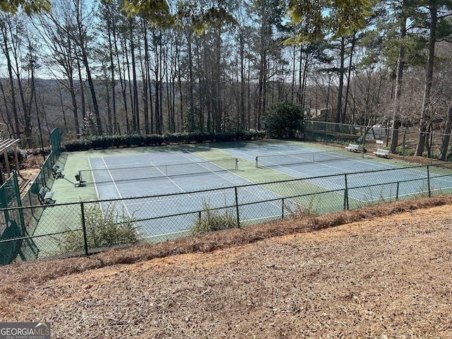 view of sport court featuring fence