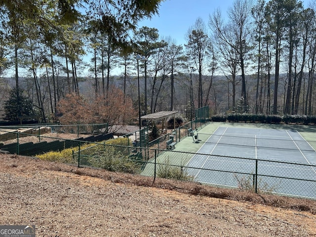 view of tennis court with fence