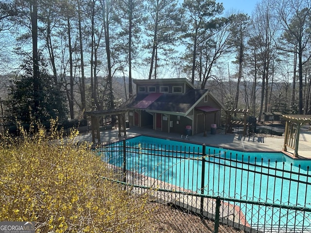 community pool featuring a patio area and fence