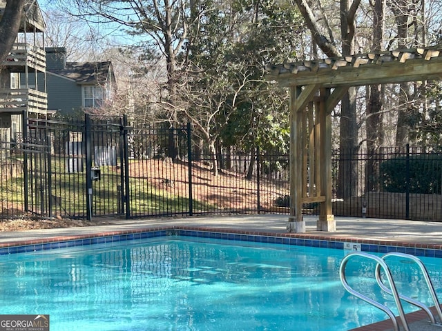 view of swimming pool with a fenced in pool and fence