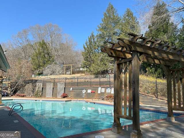 community pool featuring a pergola and fence