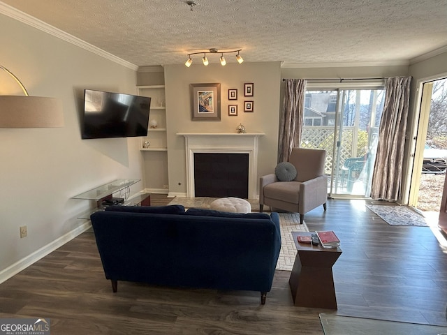 living area featuring baseboards, a fireplace, ornamental molding, dark wood-type flooring, and a textured ceiling