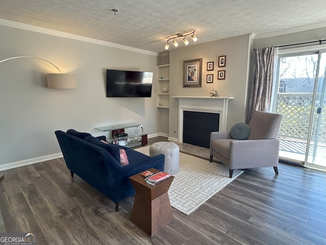 living room featuring a fireplace, dark wood-type flooring, crown molding, and a textured ceiling