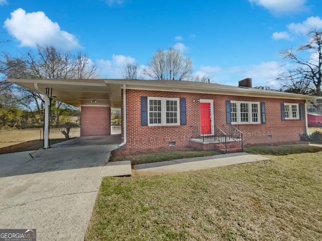 ranch-style house featuring brick siding, an attached carport, a front yard, crawl space, and driveway