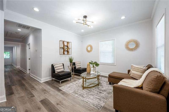 living room featuring baseboards, wood finished floors, and crown molding