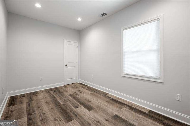 empty room featuring recessed lighting, visible vents, baseboards, and wood finished floors