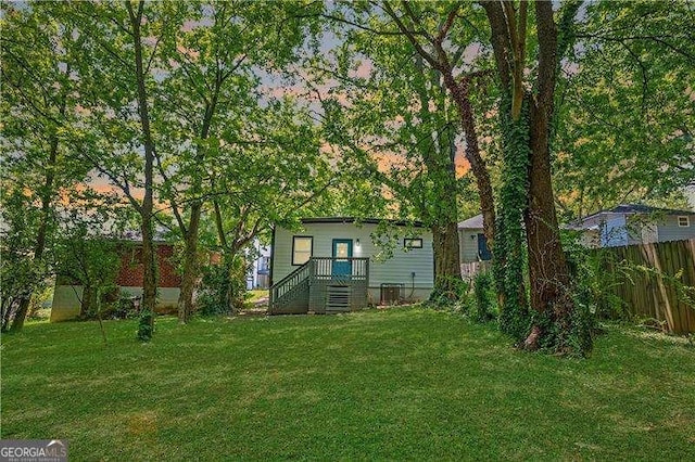 exterior space featuring a yard and fence