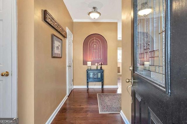 entrance foyer with baseboards, dark wood-style floors, and ornamental molding