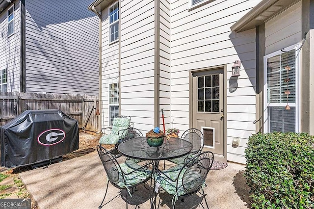 view of patio with fence, outdoor dining space, and area for grilling