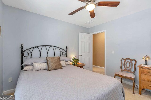bedroom with ceiling fan, baseboards, visible vents, and carpet