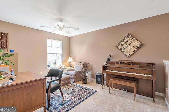 office space with ceiling fan, baseboards, and carpet flooring