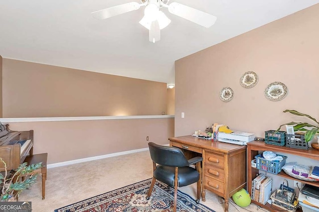carpeted office with baseboards and ceiling fan