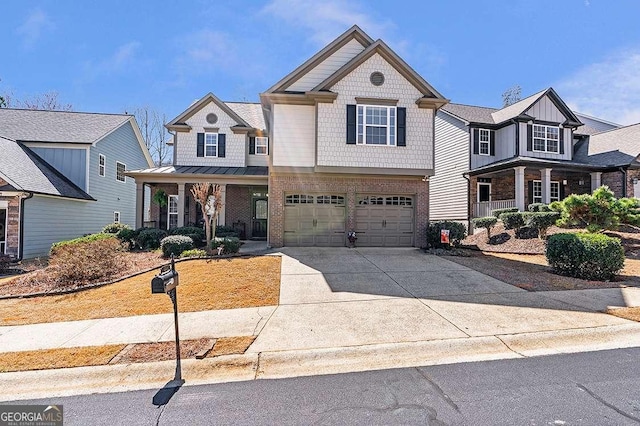 view of front of house featuring a porch, a standing seam roof, a garage, and concrete driveway