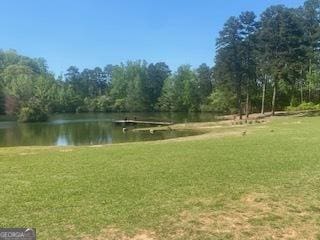 view of home's community featuring a yard and a water view