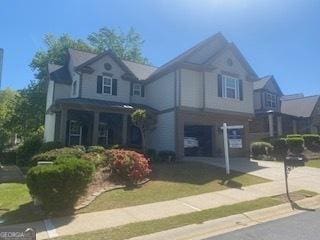 traditional-style home with concrete driveway and a garage