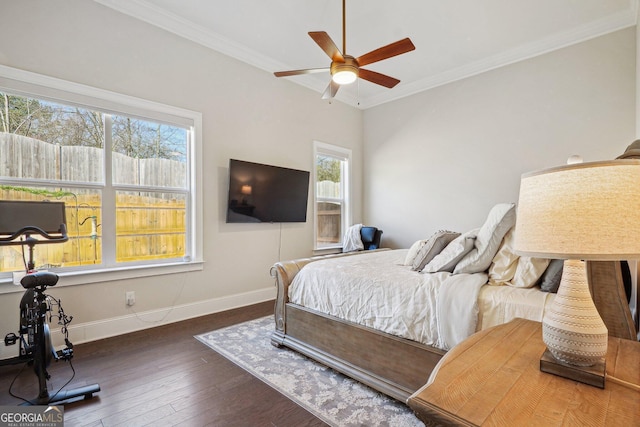 bedroom featuring hardwood / wood-style floors, crown molding, a ceiling fan, and baseboards