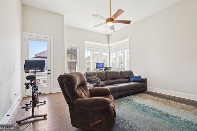 living room featuring baseboards, a healthy amount of sunlight, and hardwood / wood-style flooring