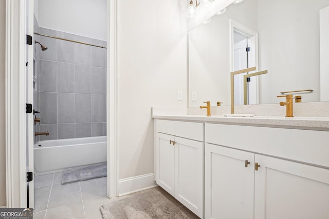 full bath featuring tile patterned floors, double vanity, shower / bathing tub combination, and a sink