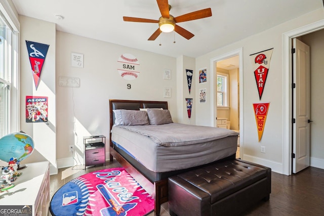 bedroom with ceiling fan, dark wood-type flooring, and baseboards