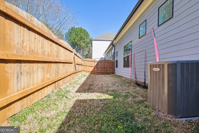 view of yard with cooling unit and a fenced backyard