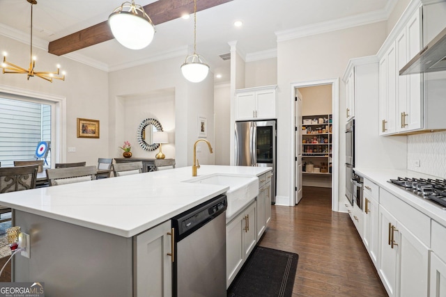 kitchen with beamed ceiling, dark wood-style flooring, a sink, appliances with stainless steel finishes, and wall chimney range hood