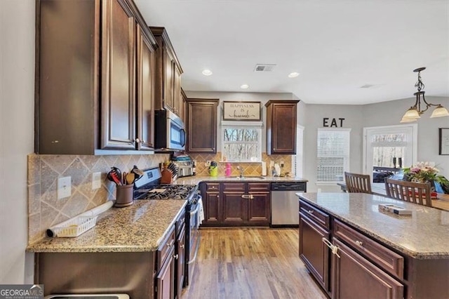 kitchen with a sink, a healthy amount of sunlight, visible vents, and stainless steel appliances