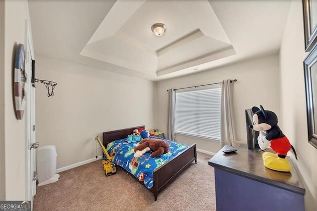 bedroom featuring a raised ceiling, baseboards, and light carpet