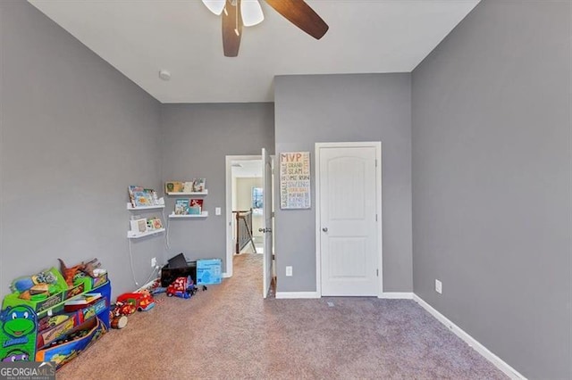 recreation room featuring baseboards, carpet, and a ceiling fan