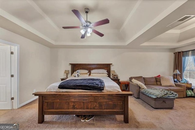 bedroom featuring a tray ceiling, baseboards, a ceiling fan, and carpet flooring