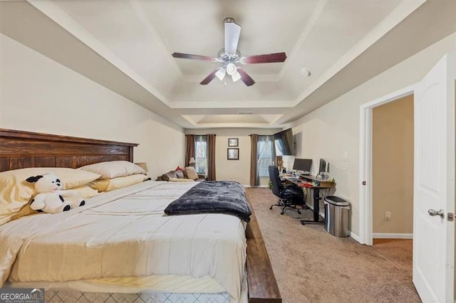 carpeted bedroom with baseboards, a raised ceiling, and ceiling fan