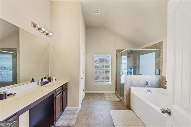 full bath featuring vanity, a stall shower, vaulted ceiling, tile patterned floors, and a bath