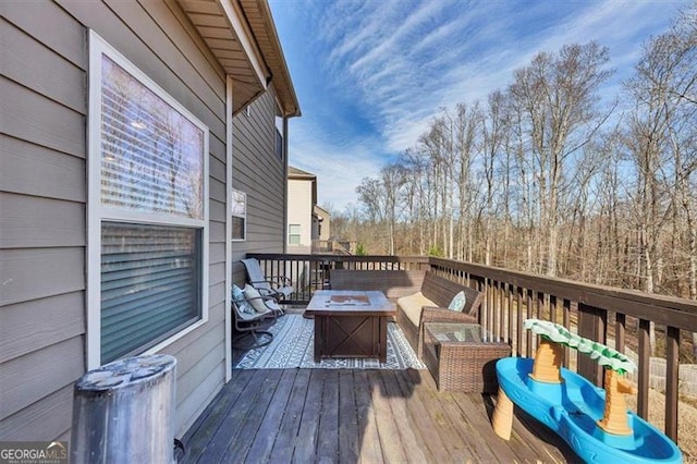 wooden terrace with an outdoor fire pit