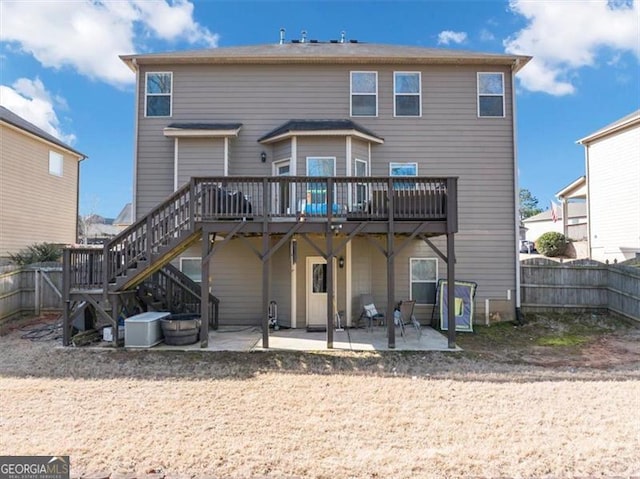 back of house featuring stairs, a patio, fence, and a wooden deck