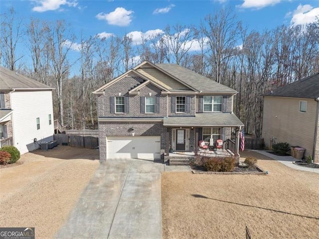 view of front of house with brick siding, covered porch, driveway, and an attached garage