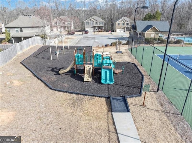 community playground featuring a residential view and fence