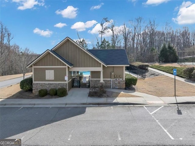 view of building exterior with a fenced front yard and an attached carport