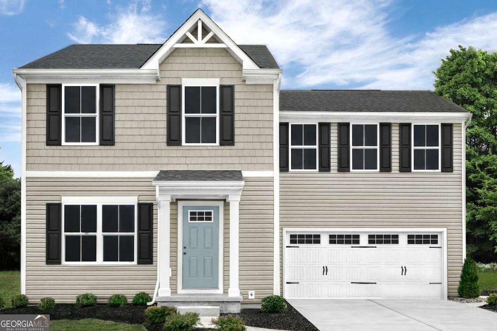 view of front of home featuring driveway, roof with shingles, and an attached garage