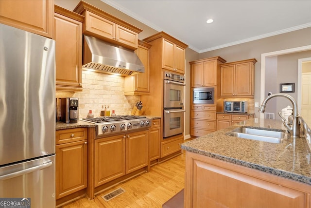 kitchen featuring visible vents, ornamental molding, under cabinet range hood, a sink, and appliances with stainless steel finishes