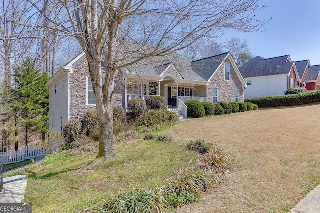 view of front of property with covered porch and stone siding