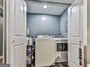 laundry area featuring laundry area, wood finished floors, and washing machine and dryer