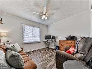 interior space with wood finished floors and ceiling fan