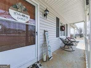 doorway to property featuring covered porch