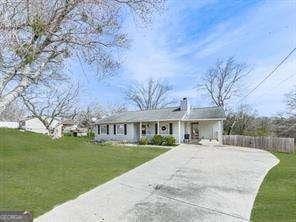 view of front of house with concrete driveway and a front yard