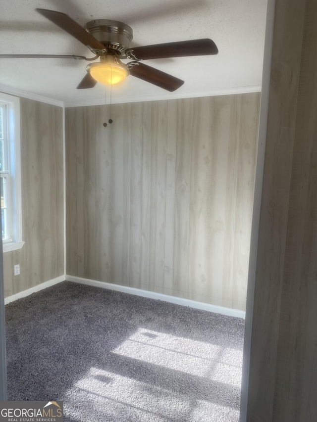 unfurnished room featuring a ceiling fan and carpet