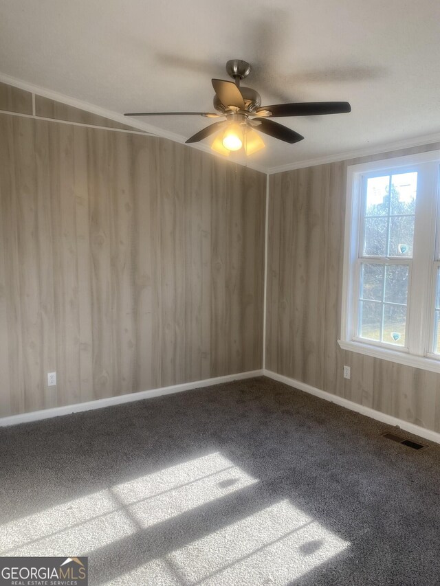 spare room with visible vents, baseboards, carpet, and ornamental molding