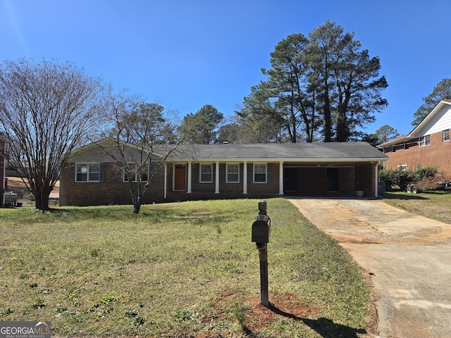 ranch-style house featuring brick siding, an attached carport, concrete driveway, and a front yard