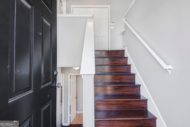 staircase with tile patterned flooring