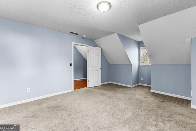 additional living space with visible vents, carpet flooring, and baseboards